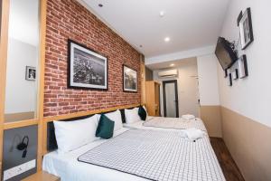 a hotel room with a bed and a painting on the wall at B Street Hotel in George Town