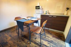 a kitchen with a table and chairs and a microwave at Inuicho Tori in Kyoto