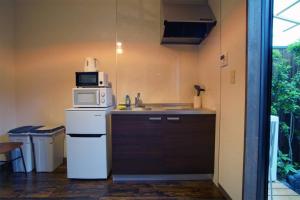a kitchen with a microwave on top of a refrigerator at Inuicho Tori in Kyoto +16 photos