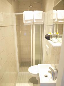 a bathroom with a shower and a toilet and a sink at Apartment Bonbon in Dubrovnik