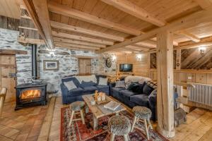 a living room with a couch and a fireplace at Colettine in Tignes