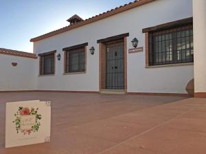 um edifício branco com uma caixa em frente em Casa Rural Los Jarales em Casar de Cáceres