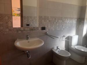 a bathroom with a sink and a toilet at B & B Patrizia in Isola Capo Rizzuto