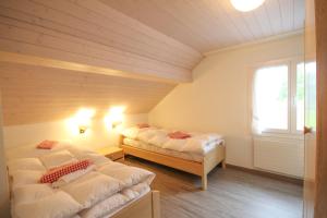 A bed or beds in a room at Chalet Bergli
