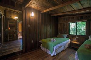 Un pat sau paturi într-o cameră la Chacra del Agua Reserva Privada