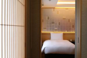 Postel nebo postele na pokoji v ubytování Enoshima Hotel ーEnoshima Island Spa Hotel Buildingー