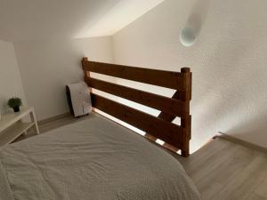 a bedroom with a wooden bed in a room at Maison de vacance Hourtin Lac in Hourtin