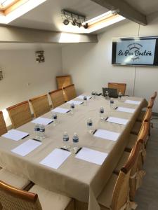 a long table in a room with chairs and a projector at Hôtel Le Peu Breton in Sainte-Marie-de-Ré +37 photos