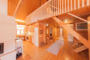 a large room with a staircase in a house at Heinähattu in Kouvola