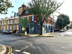 an empty street in a city with a building at Angel Townhouse in London