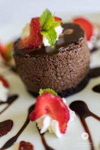 a chocolate dessert with a strawberry on a plate at Blue Marlin Hotel by Dream Resorts in Scottburgh