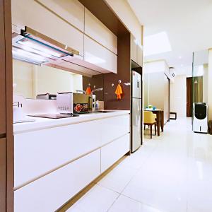 a kitchen with white appliances and a dining room at SKY POOL Luxury Suite 2-4Pax at KL City in Kuala Lumpur