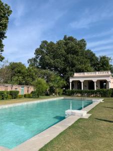 a swimming pool in front of a building at Tree of Life Resort & Spa Varanasi in Varanasi