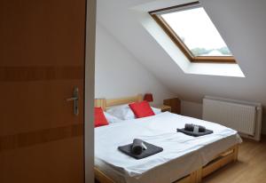 a bedroom with a bed and a window at Penzion Locanda in Brno