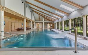 a swimming pool with a slide in a building at Columna Medica in Łask