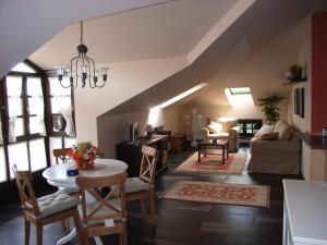 an attic living room with a table and chairs at Apartamentos Ebro Reinosa in Reinosa