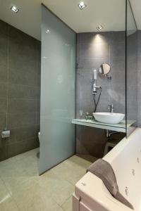
a bath room with a tub and a toilet at Atlantis Boutique City Hotel in Rhodes Town
