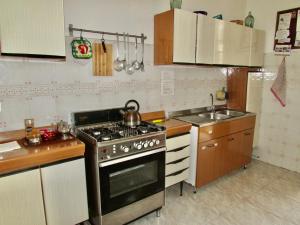 a kitchen with a stove and a sink at Guesthouse City Center in Bari