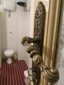a door with a gold door handle in a bathroom at Guesthouse City Center in Bari +37 photos