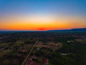 an aerial view of a city at sunset at Hotel Paraíso Dos Alpes in São Pedro