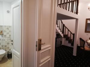 a door leading into a bathroom with a staircase at Weiss Little Palace in Braşov
