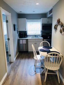 a kitchen with a table and two chairs and a table and a kitchen at Amazing beach getaway pool condo by the beach in Bradenton Beach