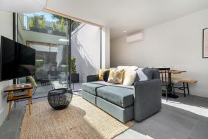 a living room with a couch and a tv at Luxury Old Town Oasis for Family and Friends (Daily Breakfast + Housekeeping incl) in Porto