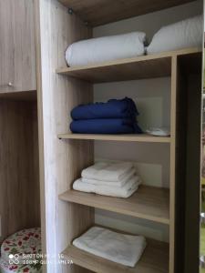 a room with wooden shelves with towels on them at NewGudauri Block 2 #308 in Gudauri