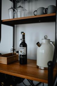 a bottle of wine sitting on a wooden shelf at Excellentas Apartments Hannover in Hannover