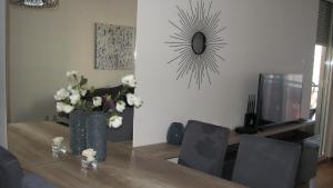 a dining room with a table with a vase of flowers at Apartments B&S Lux in Budva