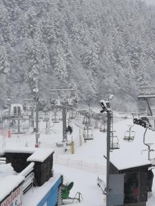 a snow covered ski slope with a ski lift at Abetone e Piramidi Resort in Abetone