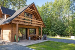 a log cabin with a porch and a patio at KARKONOSKIE CHATY in Szklarska Poręba