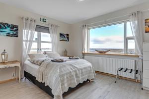 A bed or beds in a room at Guesthouse Vatnsholt