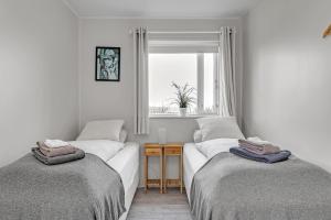 A bed or beds in a room at Guesthouse Vatnsholt