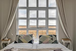A bed or beds in a room at Guesthouse Vatnsholt