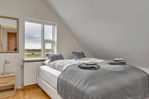 A bed or beds in a room at Guesthouse Vatnsholt