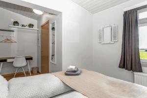 A bed or beds in a room at Guesthouse Vatnsholt