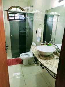 a bathroom with a sink and a toilet at Aconchego de Regina in Tiradentes