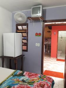 a bedroom with a mirror and a tv on the wall at Pousada da Tom-Ubatuba Perequê-Açu in Ubatuba