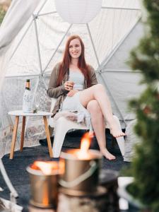 a woman sitting in a chair in a tent at FinnDome in Pori