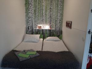 a small room with two beds and a window at Torni-Mänttä in Mänttä