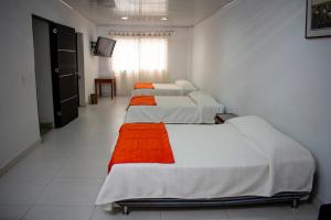 a row of beds in a room at Hotel Nova Park in Arauca