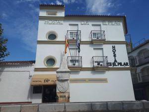 a large white building with two balconies at Hostal DP El Pilar in Monesterio +7 photos