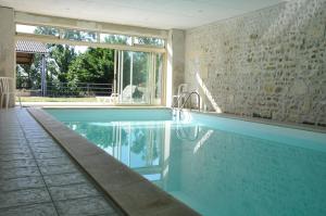 a swimming pool in a house at Roulotte Beaulieu in Saint-Jean-dʼAngle