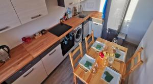 an overhead view of a kitchen with a table and chairs at Apartament Highway To Hel in Hel