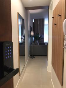 a hallway leading to a living room with a mirror at Studio Praia Copacabana Beach in Rio de Janeiro