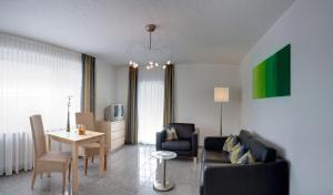 a living room with a couch and a table at Hotel-Restaurant Haus Nicklass in Ingelfingen