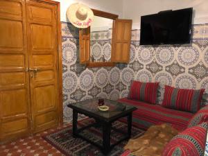a living room with a couch and a table at Dar HAJAR in Marrakech