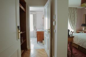 an open door to a bedroom with a bed at Ebel Boutique Hotel in Tirana