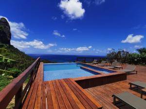 a pool on a deck with a view of the ocean at Pousada Filó in Fernando de Noronha
